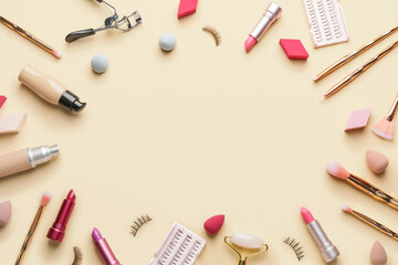 Frame made of makeup items on color background