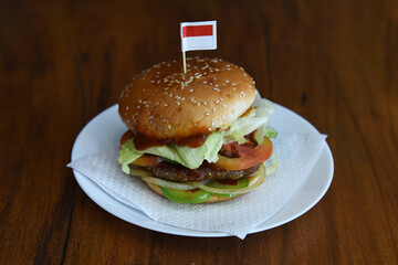 hamburger on a plate with indonesian's flag on top