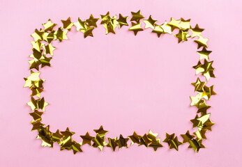 Frame made of confetti on color background