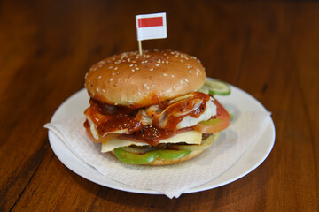 hamburger on a plate with indonesian's flag on top