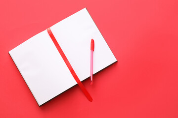Blank book with bookmark and pen on color background