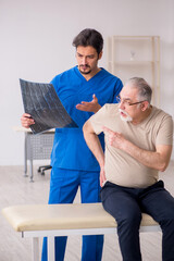 Fototapeta premium Old male patient visting young male doctor radilogist