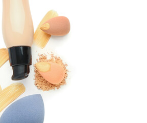 Fototapeta na wymiar Bottle of makeup foundation, sponges and samples on white background