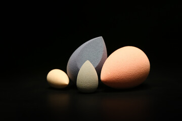 Composition with makeup sponges on dark background