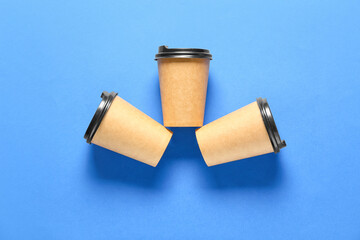 Blank paper cups on color background