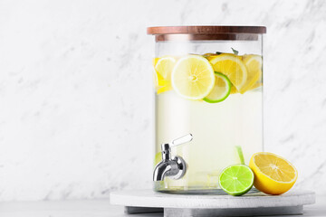 Jug of tasty cold lemonade on light background - obrazy, fototapety, plakaty