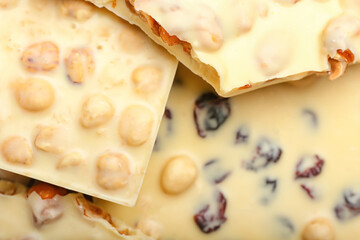 Sweet white chocolate with nuts as background, closeup