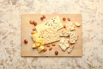 Composition with white chocolate and nuts on grunge background