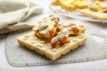 Delicious white chocolate with nuts on  table