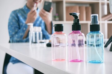 Decorative cosmetics makeup set on table. Woman blogger vlogger is showing cosmetics products with recording video 