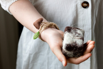 A girl's hand with felted woolen soap. The concept of a washcloth peeling. Self-care.