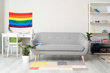 Sofa and flag of LGBT in interior of living room