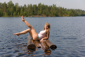 girl sitting on a raft in summer - obrazy, fototapety, plakaty