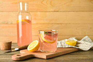 Composition of tasty grapefruit lemonade on wooden background