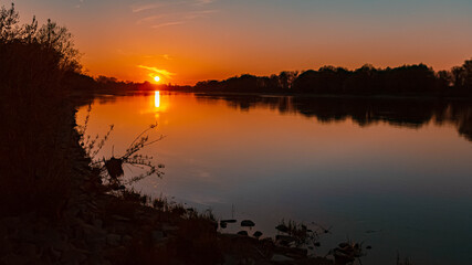 Fototapeta na wymiar Beautiful sunset with reflections near Stephansposching, Danube, Bavaria, Germany