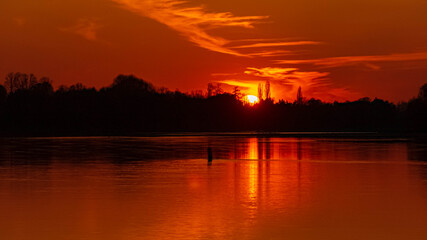Fototapeta premium Beautiful sunset with reflections near Stephansposching, Danube, Bavaria, Germany