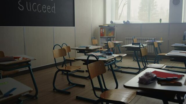 Classroom with desks and chairs in school. Interior of elementary school class