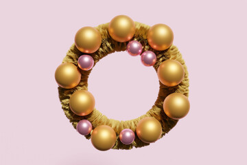 3d render of gold Christmas wreath with shiny gold baubles on a pink background