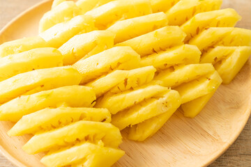 fresh pineapple sliced on plate