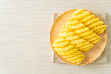fresh pineapple sliced on plate