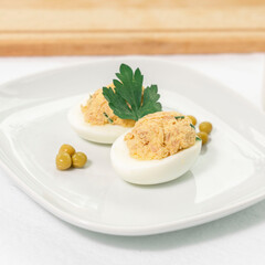 stuffed eggs with canned tuna, peas and herbs