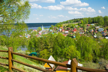 Fototapeta na wymiar Scenic view of small and picturesque town of Plyos on bank of Shokhonka river in springtime, Russia