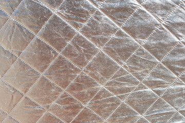 A background view of a silver reflective fabric.