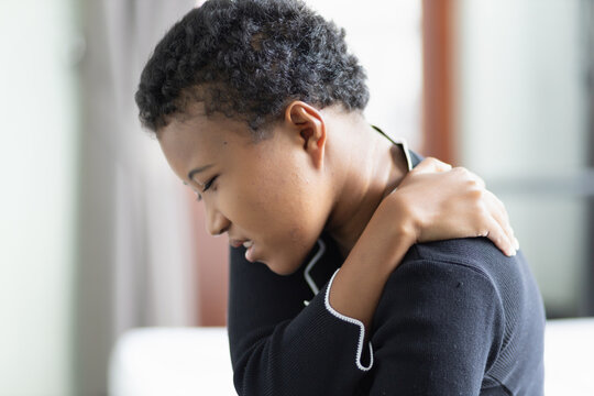 Black African Woman Suffers From Shoulder Joint Pain, Shoulder Stiffness Or Osteoporosis Or Having Pain At Injection Site As A Side Adverse Effect After Vaccination At Upper Arm Muscle