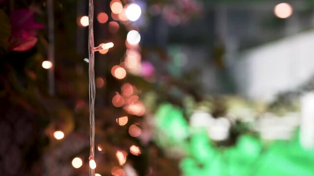 Decorative light bulbs on wire. Beautiful fancy Christmas lights. Close up of bright wired led lights. 