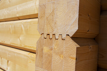 Fragment of a construction built of glued pine timber beams.