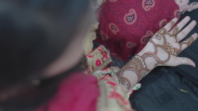 Woman&rsquo;s hands full of beautiful mehndi designs. Bride with mehndi designs on her hands at Indian marriage ceremony