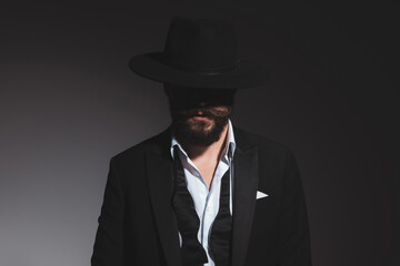 portrait of a mysterious businessman wearing a black hat