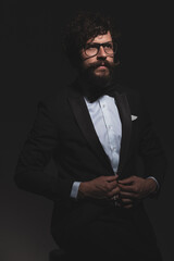 handsome businessman opening his jacket, wearing eyeglasses