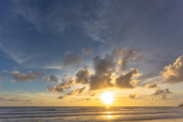 Majestic sunset or sunrise landscape Amazing light of nature cloudscape sky and Clouds moving away rolling .Beautiful Phuket beach is a famous tourist destination in Andaman sea summer. 