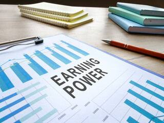 Earning power report with charts and pen.