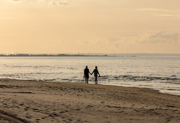 Romantic walk of a couple in love on the beach in Stegna, Pomerania. Poland