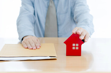 A Businessman sent filing for home loan. document and small red home