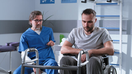 Mature doctor speaking with handicapped patient