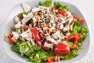 Fresh vegetables salad with feta cheese and roasted sunflower seeds