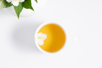 Jasmine tea and jasmine flowers.Teapot with jasmine flowers on white background. Flat lay, top view, copy space