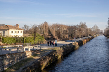 Fototapeta premium Robecco sul Naviglio ( MI ), Italy - April 01, 2021: Robecco sul Naviglio town and Naviglio Grande, Milano, Lombardy, Italy
