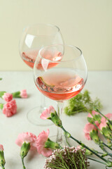 Glasses of pink wine and beautiful flowers