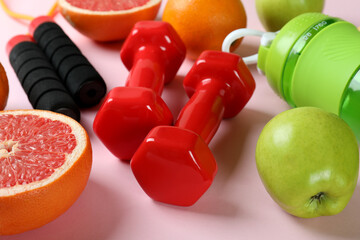 Healthy lifestyle accessories on pink background, close up