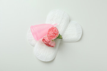 Concept of menstruation on white background, top view