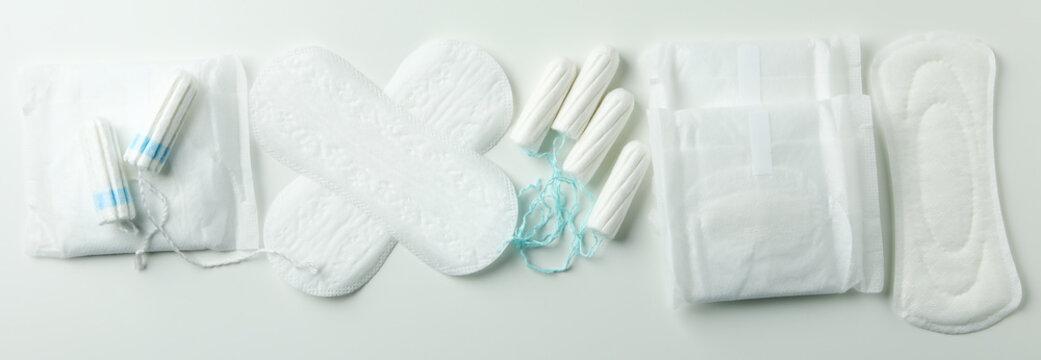 Concept of menstruation on white background, top view