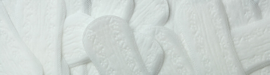 Hygiene pads on whole background, top view