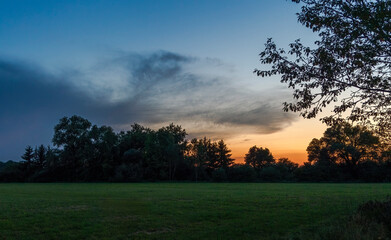 Sunset over the edge of a forest