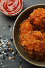 Concept of tasty eating with fried chicken on dark wooden background