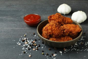 Concept of tasty eating with fried chicken on dark wooden background