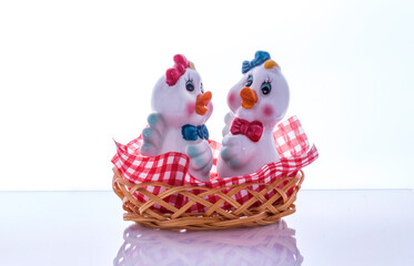 Porcelain salt and pepper shakers in the form of chickens on the table